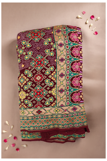 Royal Maroon Bandhani And Patola Print Saree With Intricate Zari Border