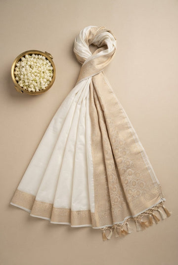 Elegant Off-White Banarasi Silk Saree With Woven Golden Zari Border And Tassels