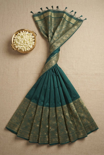 Elegant Deep Teal Green Silk Saree With Ornate Golden Zari Border And Tassels
