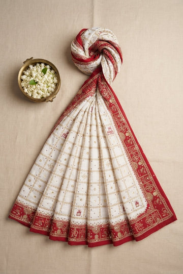 Elegant Off-White And Red Festive Saree With Traditional Gold Zari Grids And Auspicious Motifs